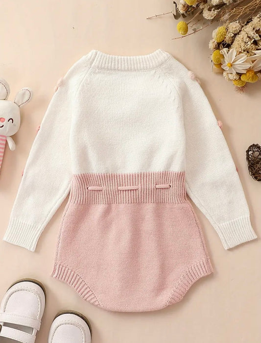 Pom-Pom Heart Knit Baby Romper – Blush & Cream. Available in sizes: 0-3m, 3-6m , and 9-12m