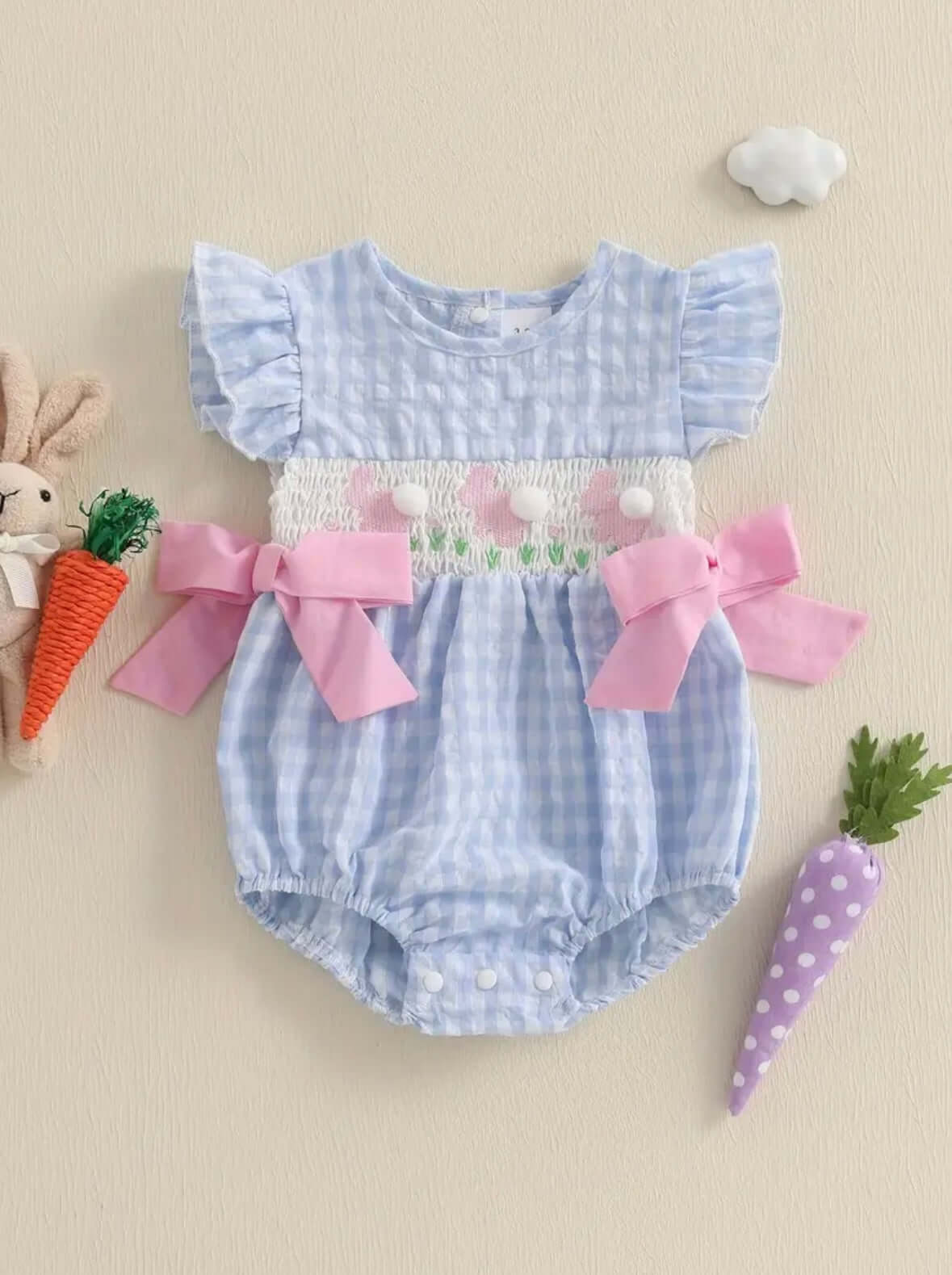 Blue gingham baby romper with ruffled sleeves and pink bows, perfect for spring and summer wear.