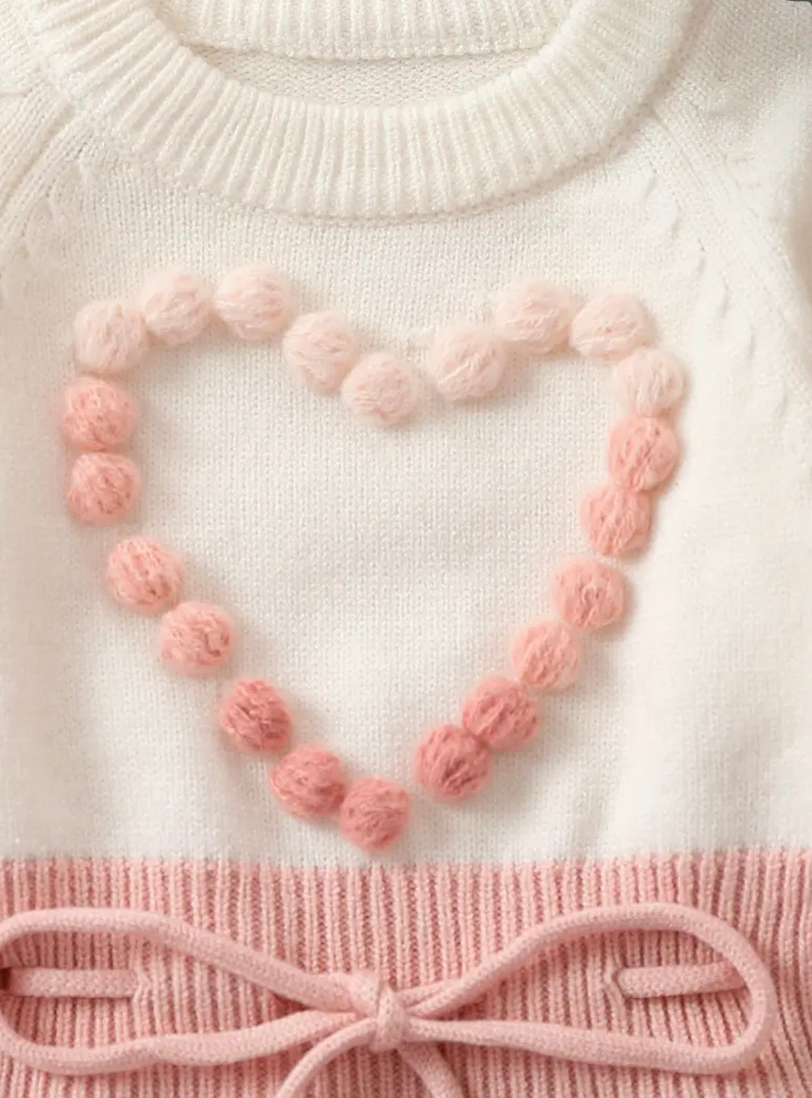 Pom-Pom Heart Knit Baby Romper – Blush & Cream. Available in sizes:  0-3m,  3-6m , and  9-12m