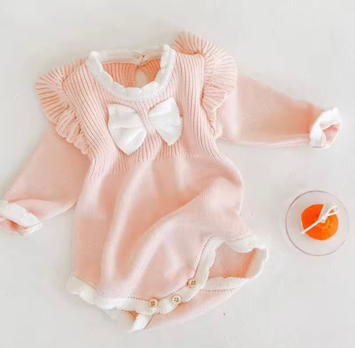 Blush Pink Knit Baby Romper with Ruffle Sleeves & Bow